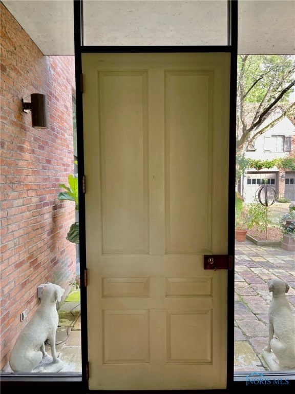 doorway with brick wall