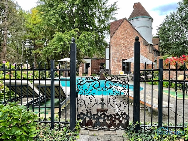 view of gate featuring a fenced in pool