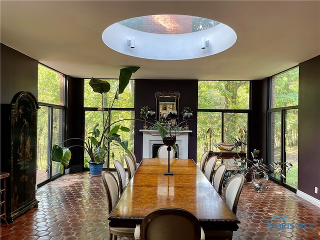 tiled dining room with plenty of natural light and floor to ceiling windows