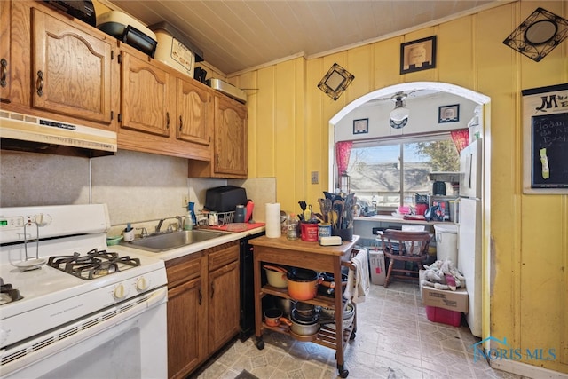 kitchen featuring dishwasher, light tile floors, sink, and gas range gas stove