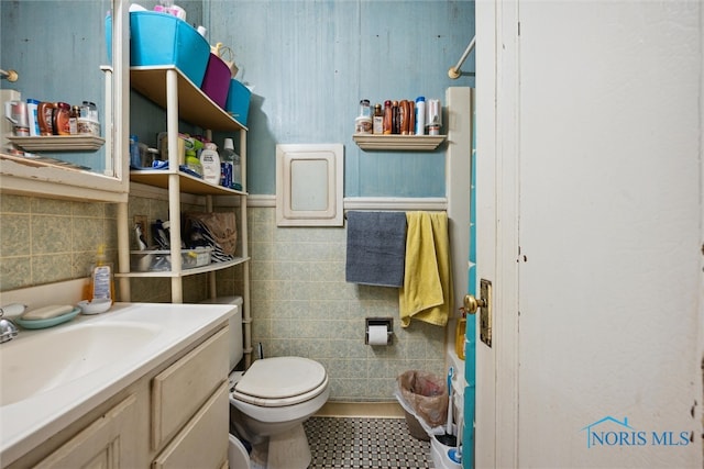 bathroom with vanity, tile floors, and toilet