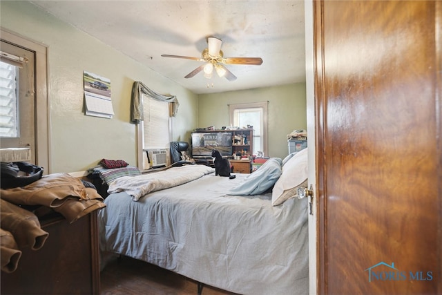 bedroom featuring dark hardwood / wood-style flooring and ceiling fan