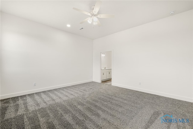 carpeted spare room featuring ceiling fan