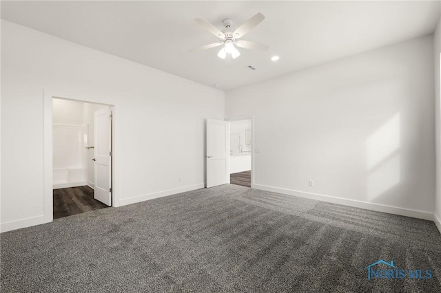 unfurnished bedroom featuring ceiling fan and dark colored carpet