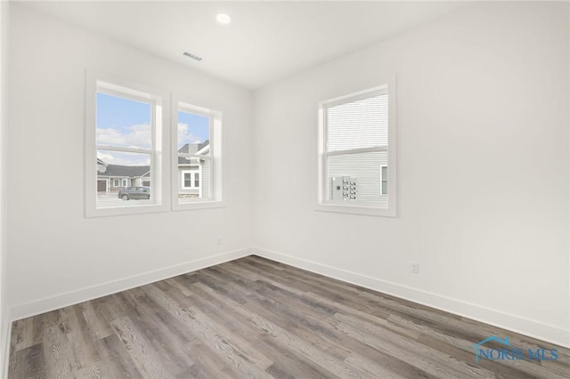 unfurnished room with wood-type flooring