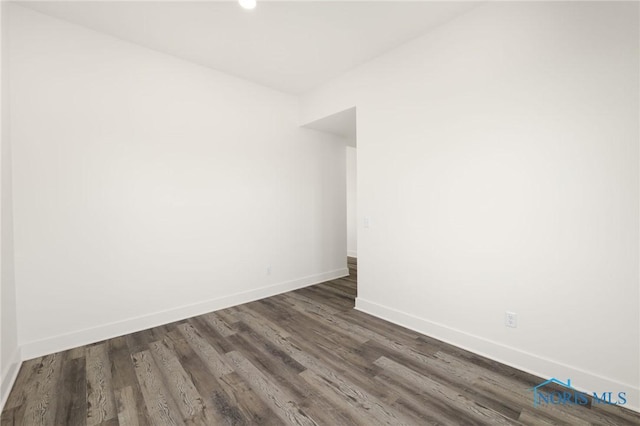 unfurnished room featuring dark hardwood / wood-style floors