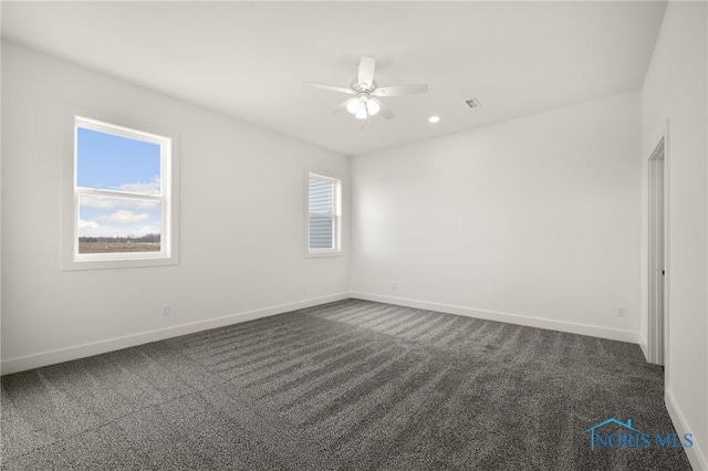 carpeted spare room with ceiling fan