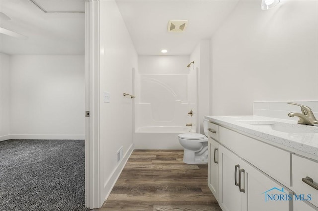 full bathroom with bathtub / shower combination, vanity, toilet, and wood-type flooring