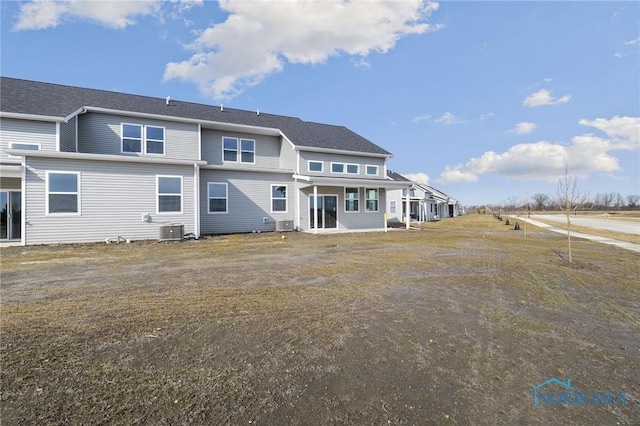 rear view of property with central AC unit