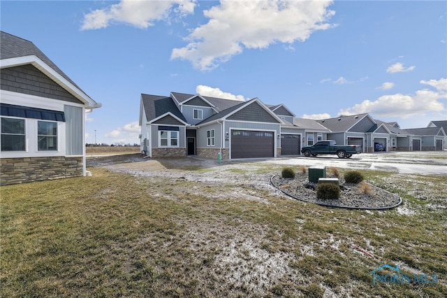 craftsman inspired home with a garage and a front lawn