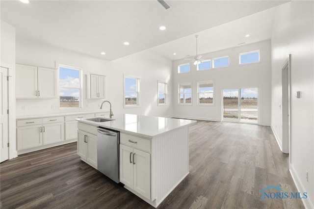 kitchen with sink, dishwasher, white cabinetry, a kitchen island with sink, and dark hardwood / wood-style flooring