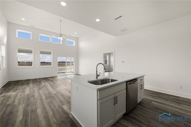 kitchen with sink, stainless steel dishwasher, dark hardwood / wood-style floors, gray cabinets, and an island with sink