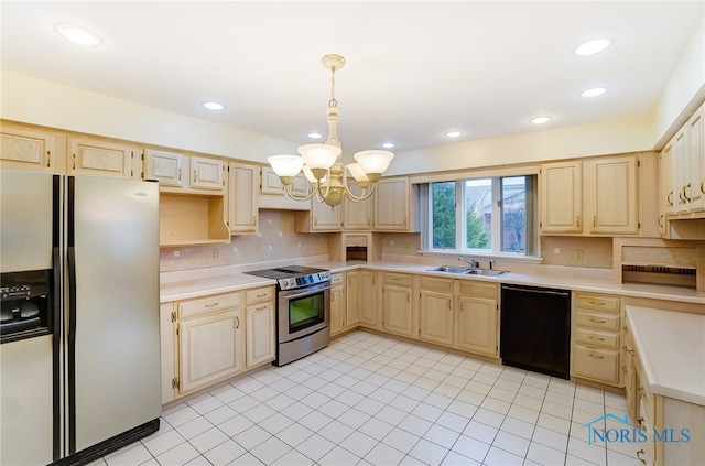 kitchen with appliances with stainless steel finishes, light brown cabinets, sink, and a chandelier