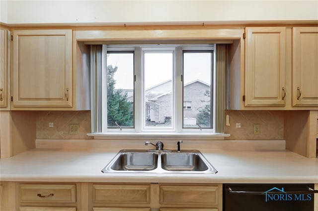 kitchen with light brown cabinetry, tasteful backsplash, a healthy amount of sunlight, and sink