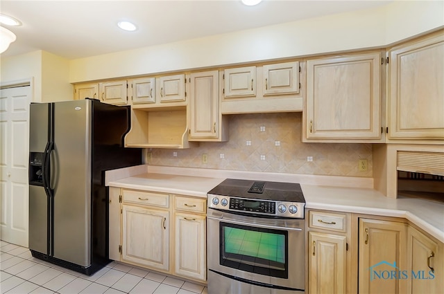 kitchen featuring backsplash, light brown cabinets, light tile floors, and appliances with stainless steel finishes