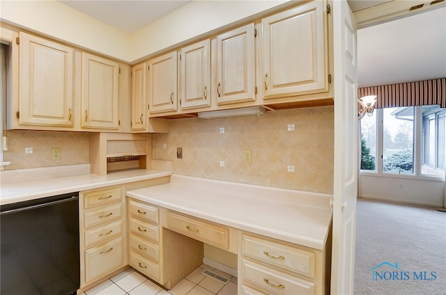 kitchen featuring dishwasher, built in desk, light carpet, and tasteful backsplash