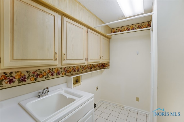 washroom featuring light tile floors, hookup for a washing machine, sink, hookup for an electric dryer, and cabinets