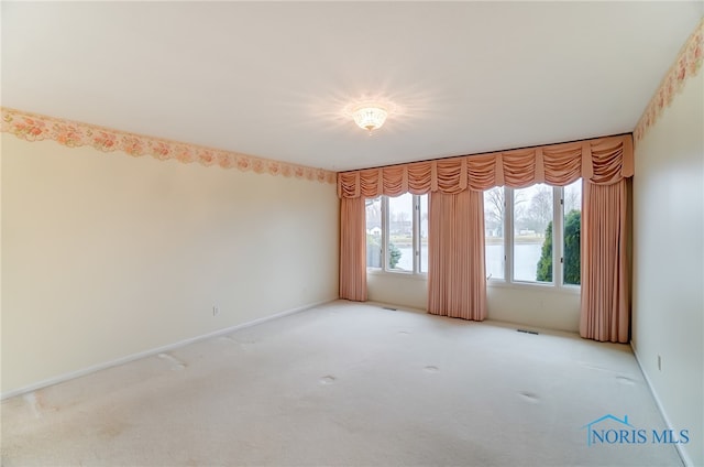 unfurnished room with light carpet