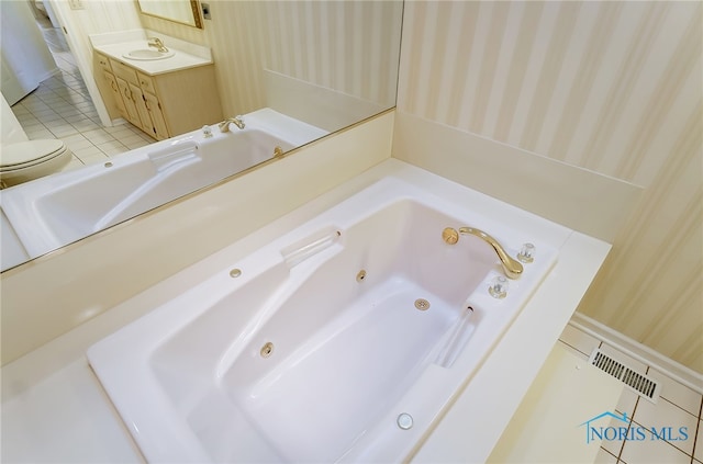 bathroom featuring oversized vanity, toilet, and tile flooring