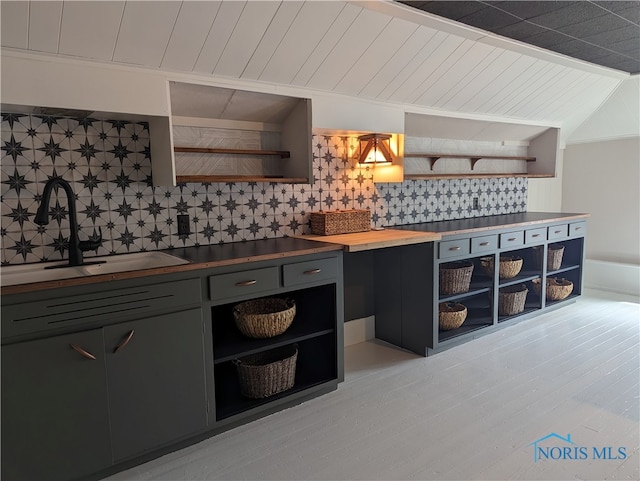 kitchen with wooden counters, sink, and tasteful backsplash