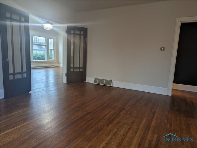 interior space with baseboard heating and dark hardwood / wood-style floors