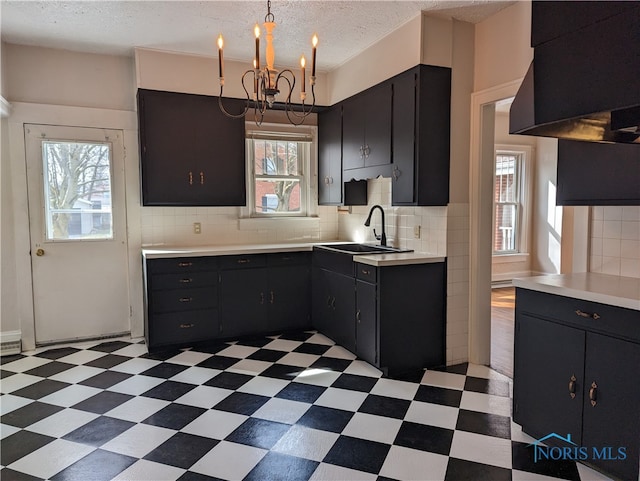 kitchen with plenty of natural light, decorative backsplash, and dark tile patterned floors