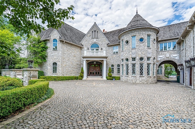 french country style house featuring a balcony