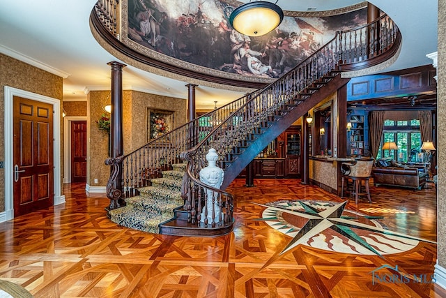 interior space with parquet flooring, ornate columns, and crown molding