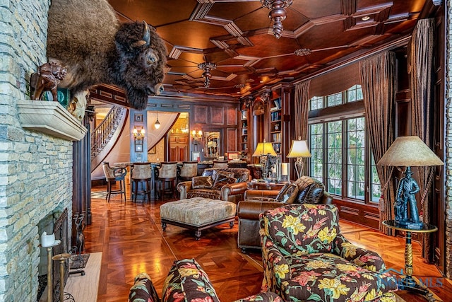 living room featuring coffered ceiling, ceiling fan, parquet floors, and crown molding