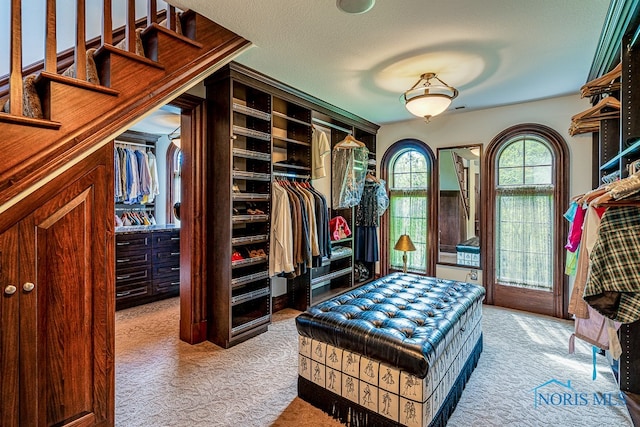 mudroom featuring a textured ceiling and carpet