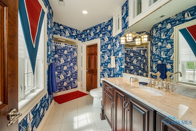 bathroom featuring toilet, vanity, and tile patterned floors