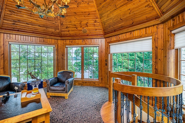 carpeted bedroom with wooden walls, multiple windows, vaulted ceiling, and wooden ceiling