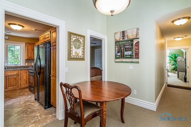 tiled dining area with a textured ceiling