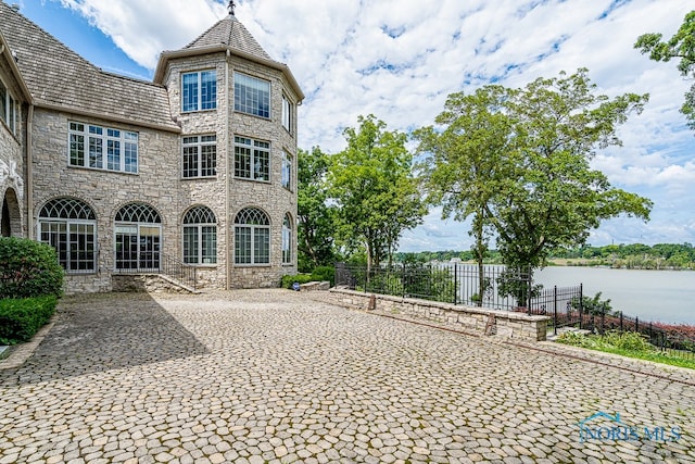 rear view of property featuring a water view