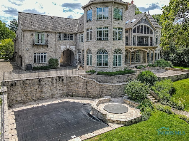 rear view of property with a patio and a balcony