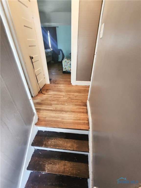 stairway featuring light wood-type flooring