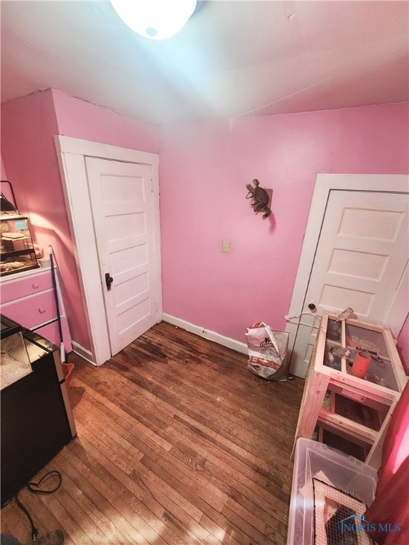 bedroom with dark wood-type flooring