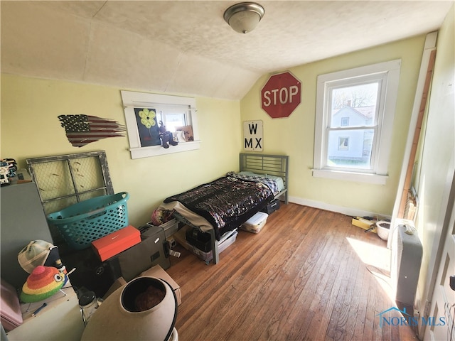 bedroom featuring dark hardwood / wood-style flooring and vaulted ceiling