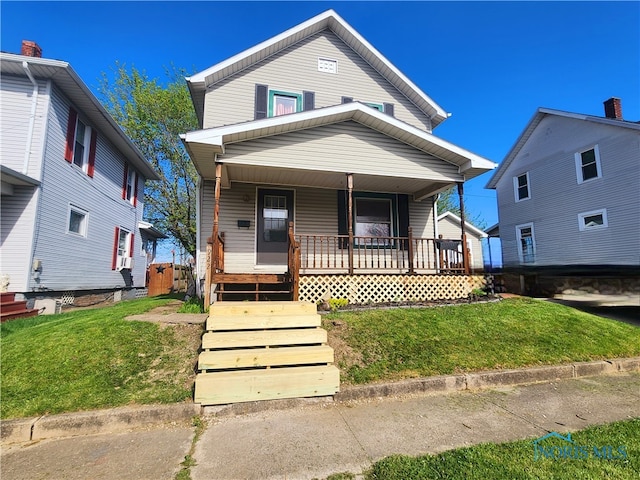 view of front facade with a front lawn and covered porch