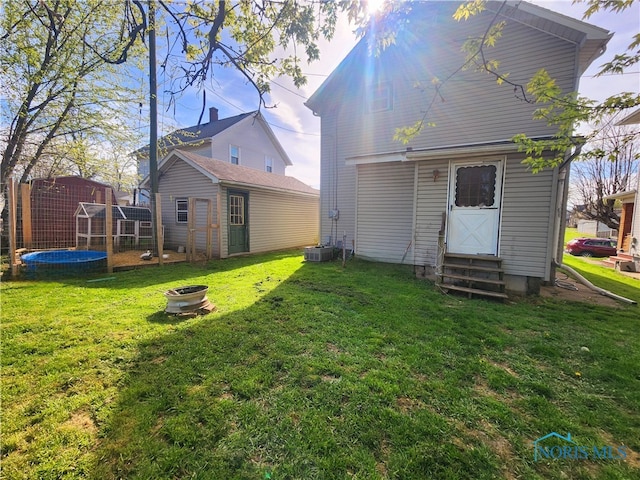 rear view of house featuring a lawn