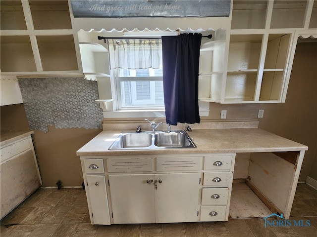 kitchen featuring sink and white cabinetry