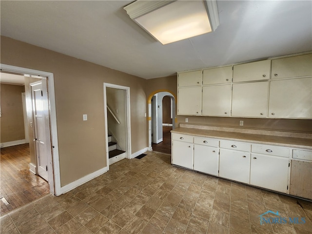 kitchen with tile flooring and white cabinetry