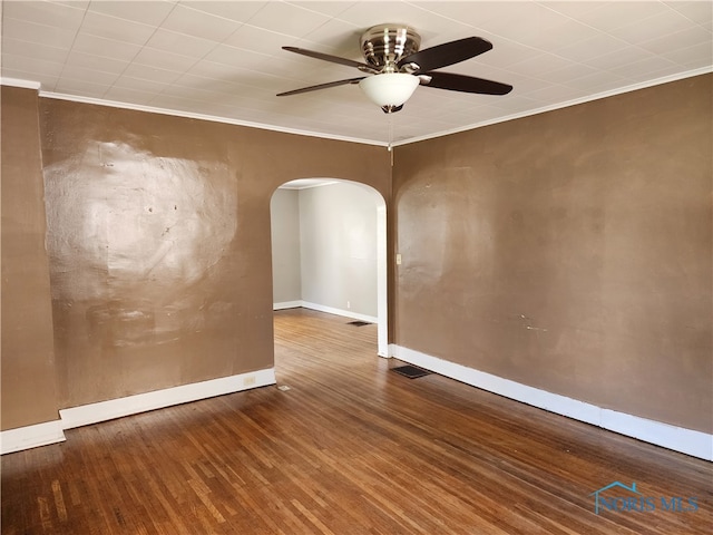 empty room featuring ceiling fan, dark hardwood / wood-style flooring, and ornamental molding