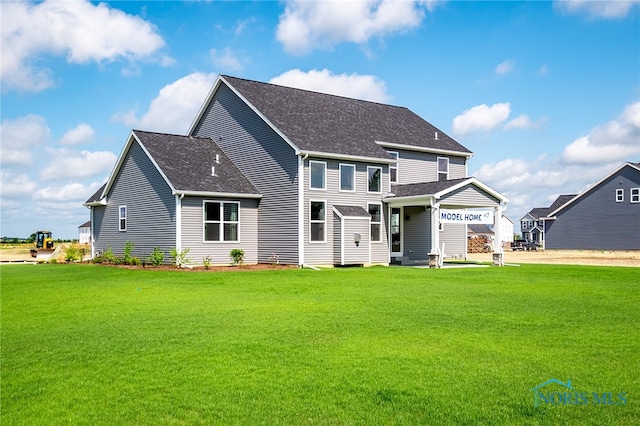 rear view of property featuring a yard