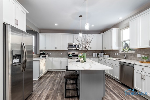 kitchen featuring appliances with stainless steel finishes, white cabinetry, and a kitchen island