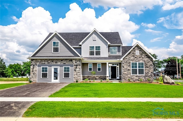 craftsman inspired home with a front lawn