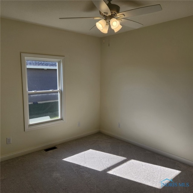 spare room featuring carpet flooring and ceiling fan