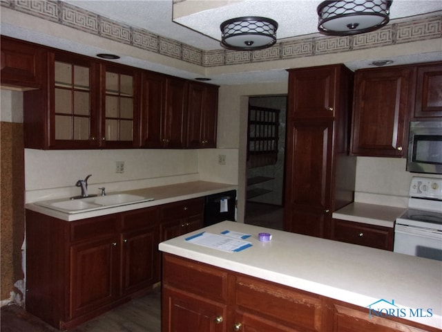 kitchen featuring sink, electric stove, stainless steel microwave, and a textured ceiling