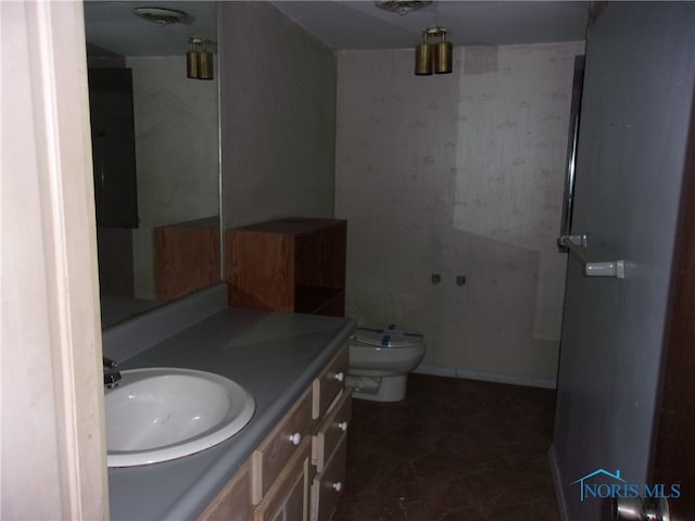 bathroom with tile floors, oversized vanity, and toilet