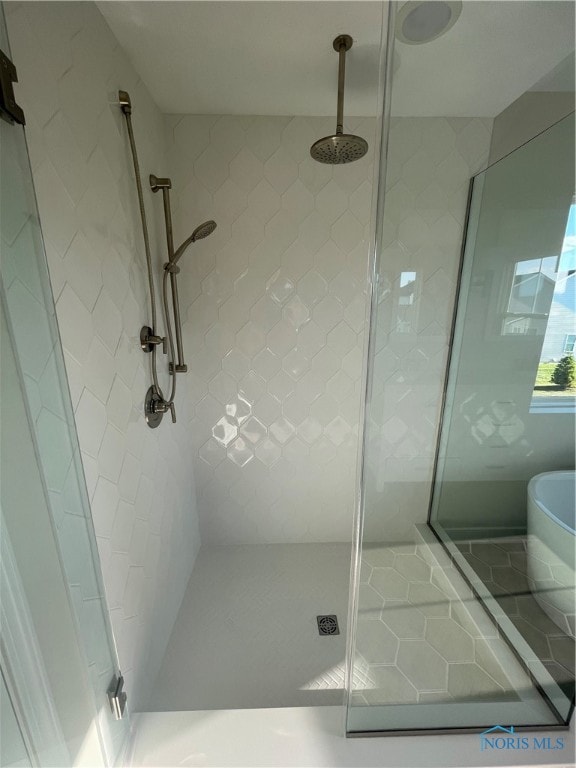 bathroom with a shower with door